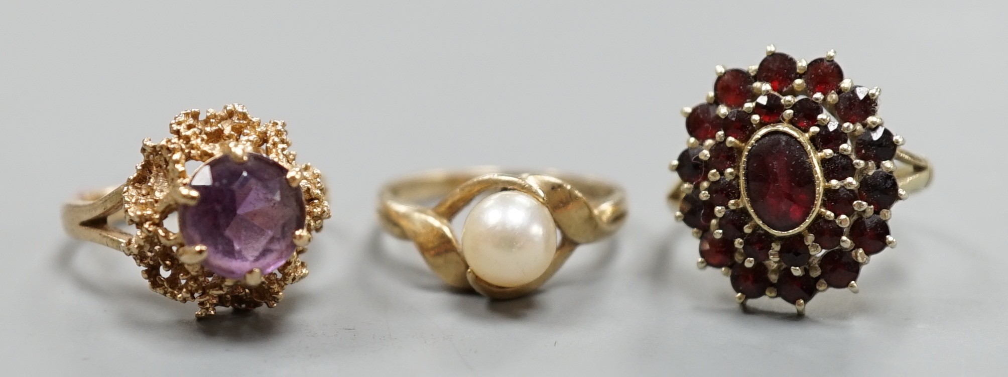 Two modern 9ct gold dress rings, one set with cultured pearl, the other with amethyst, gross weight 6.5 grams and an Austro-Hungarian yellow meta and garnet cluster ring, gross 4.4 grams.